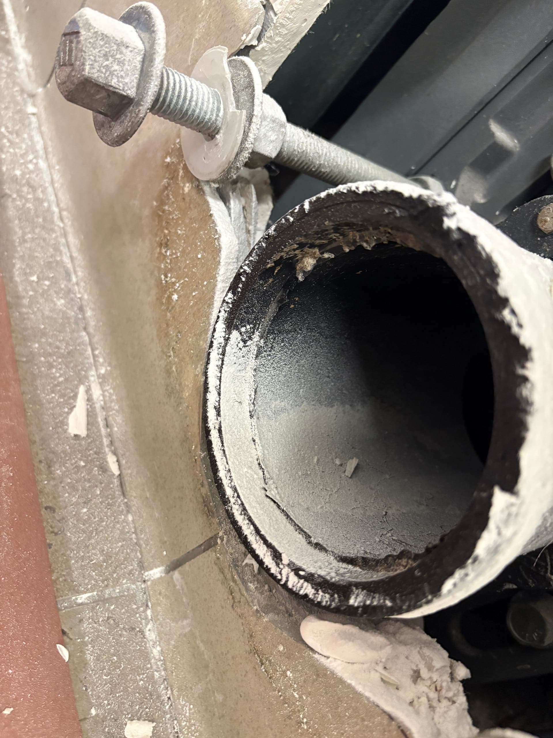 A cut, corroded waste pipe end exposed for repair