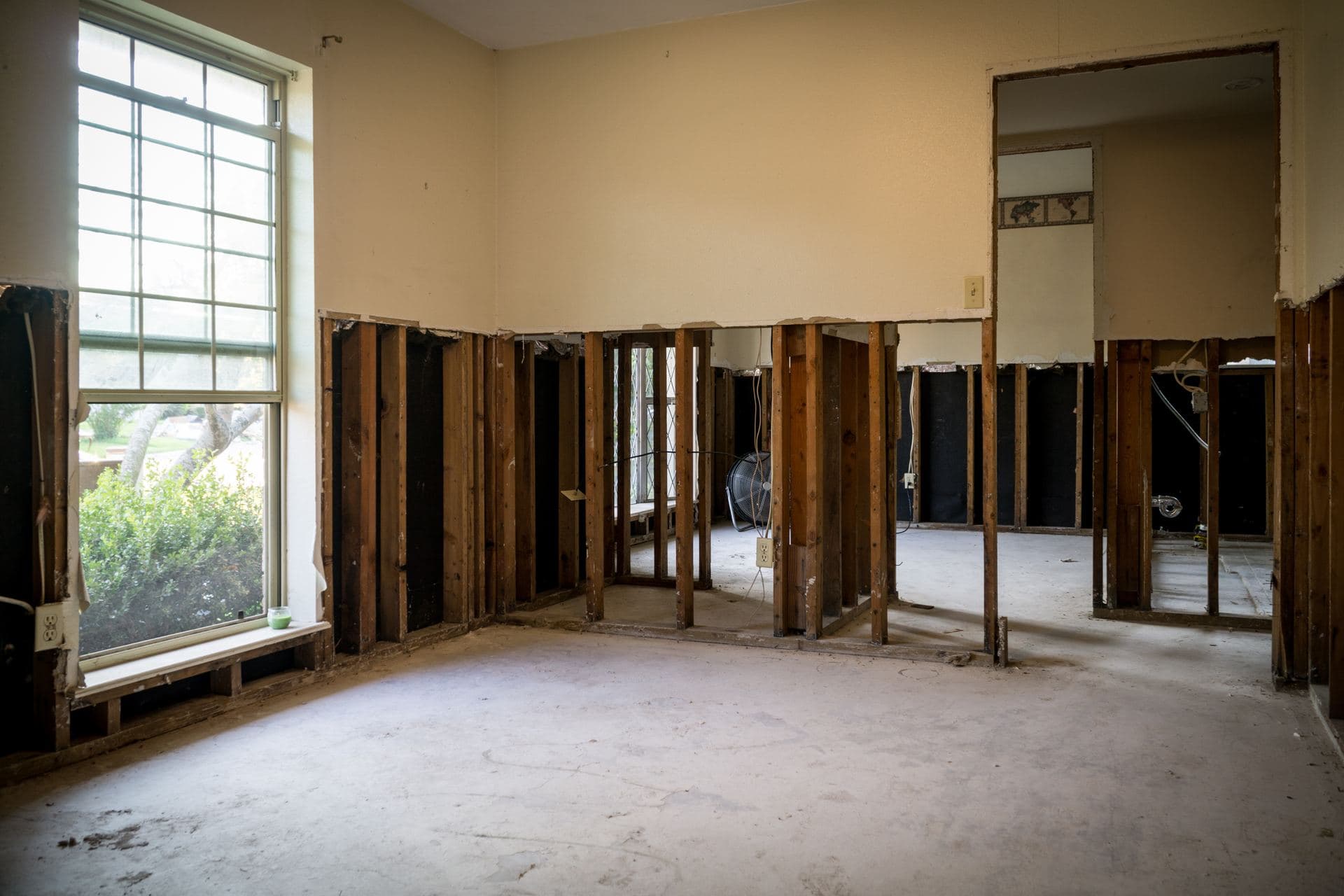 A flooded room with walls flood-cut back to the studs for drying