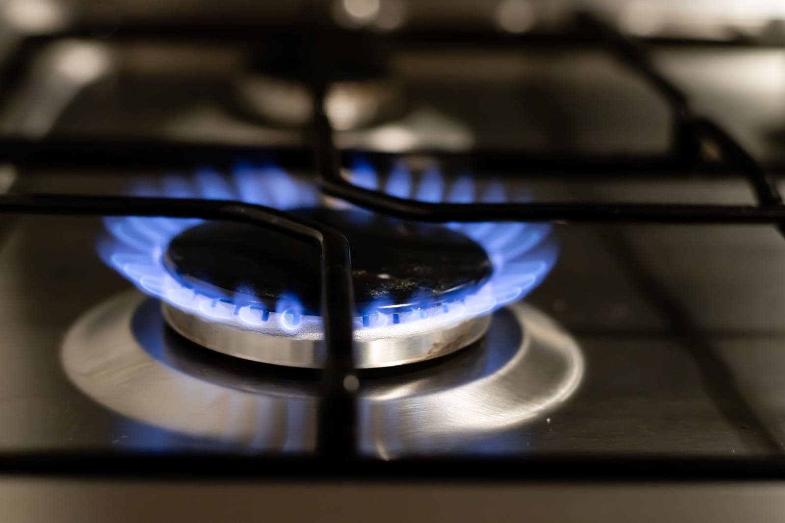 A lit gas stovetop burner, the most common starting point for a kitchen fire