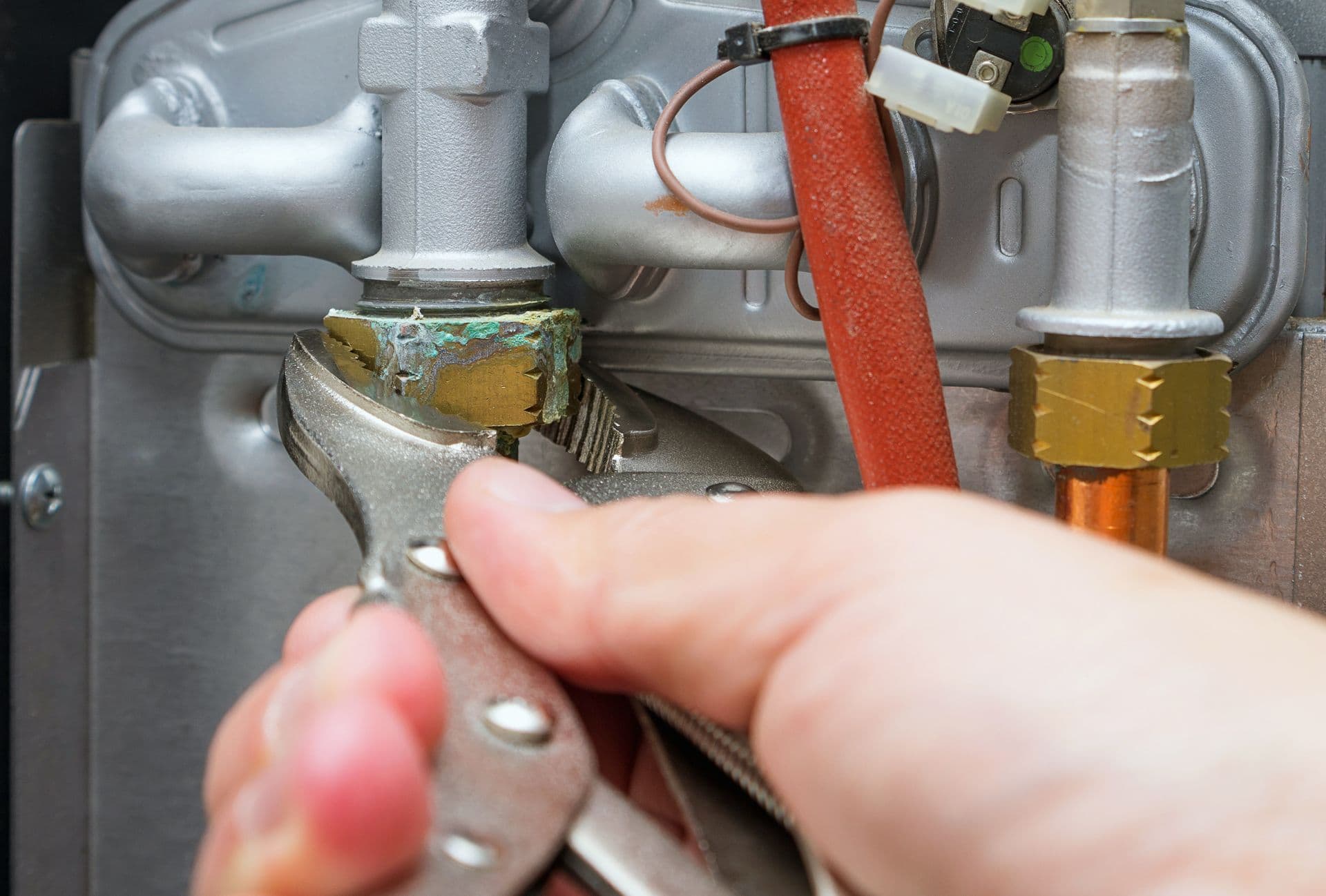 Close-up of the supply-line fittings on top of a residential water heater