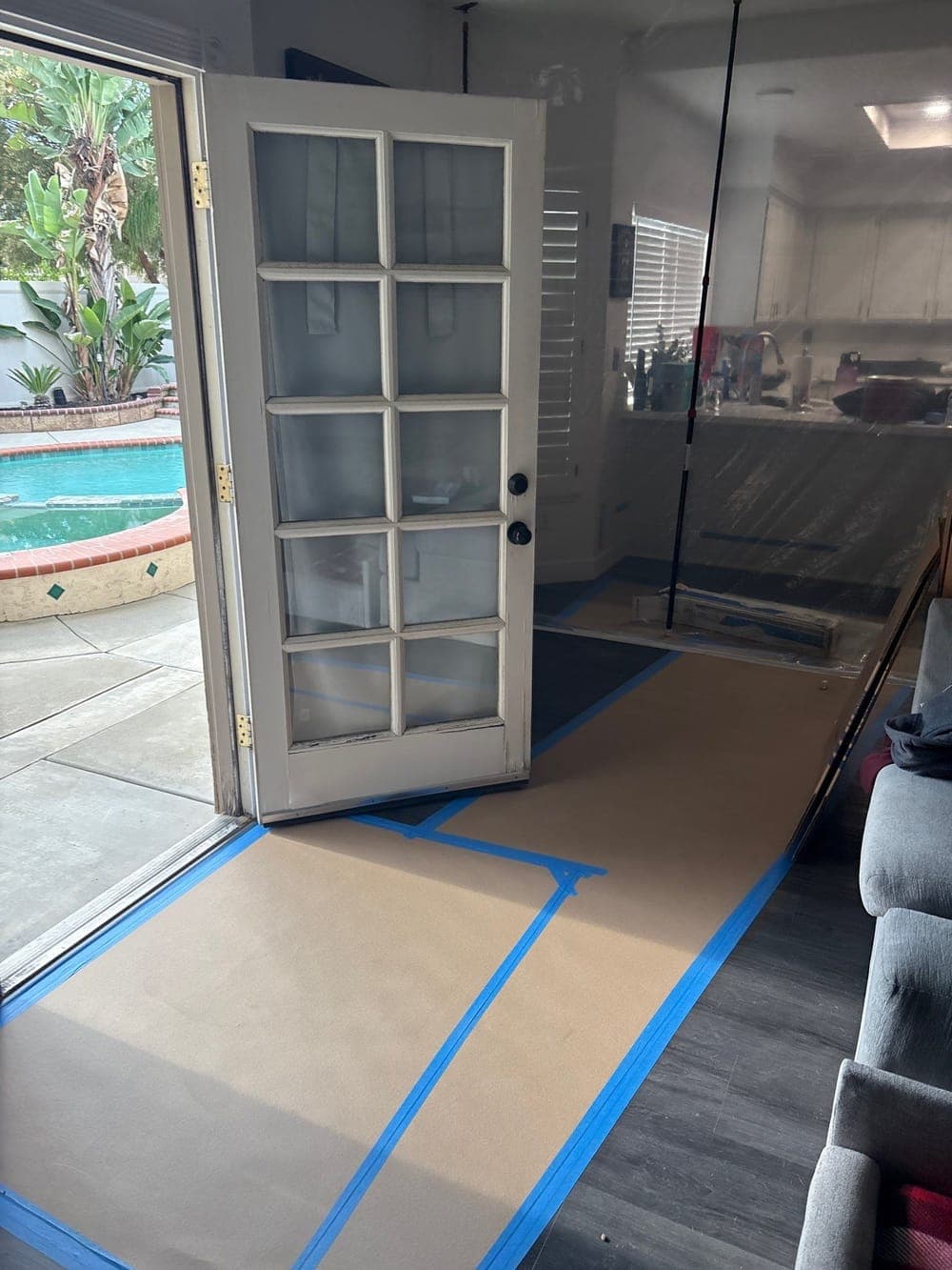 Protective paper taped across an entryway floor to keep the route in clean on a Resolve Residential Restoration job