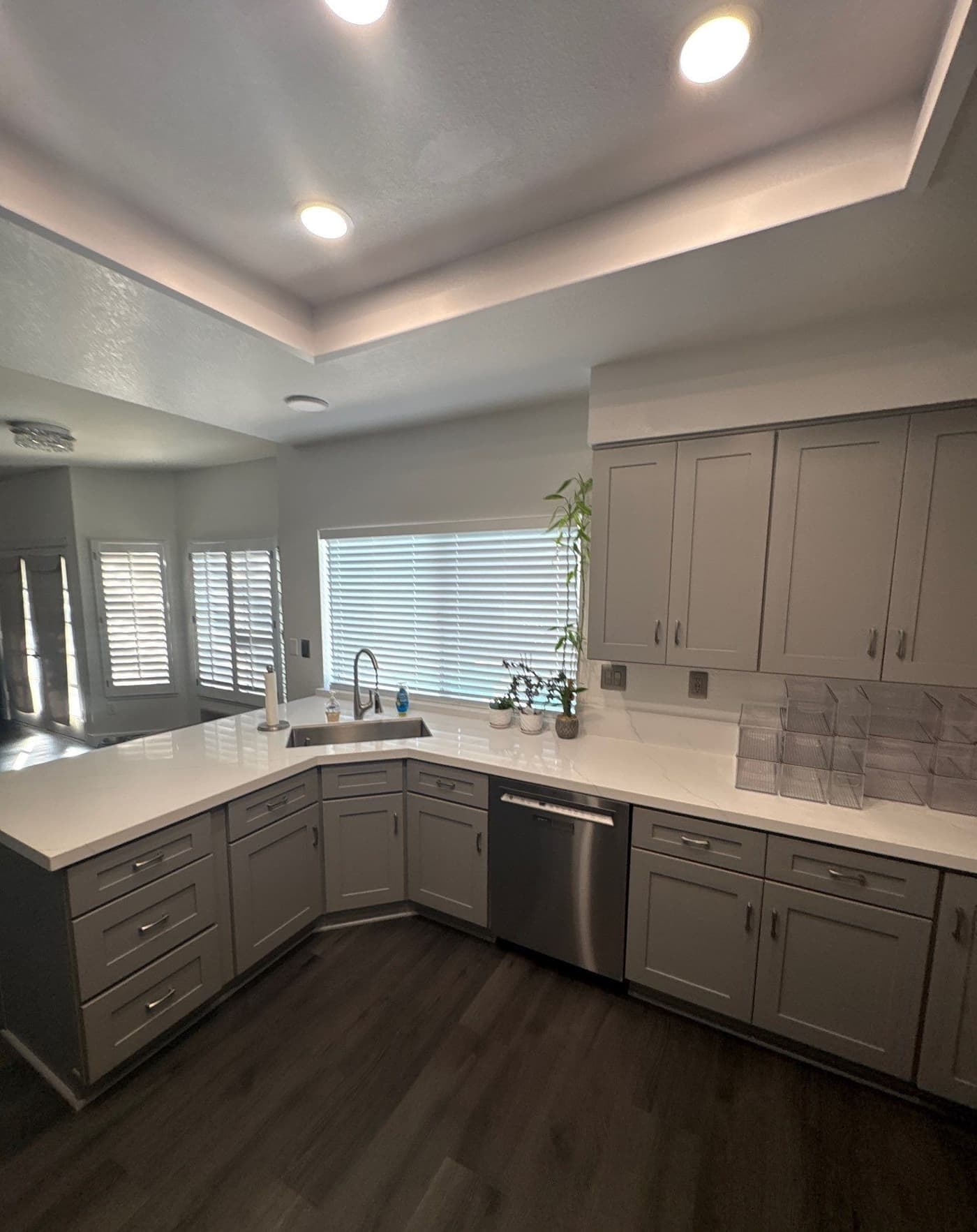 A kitchen rebuilt after restoration, with new cabinets, quartz counters and flooring