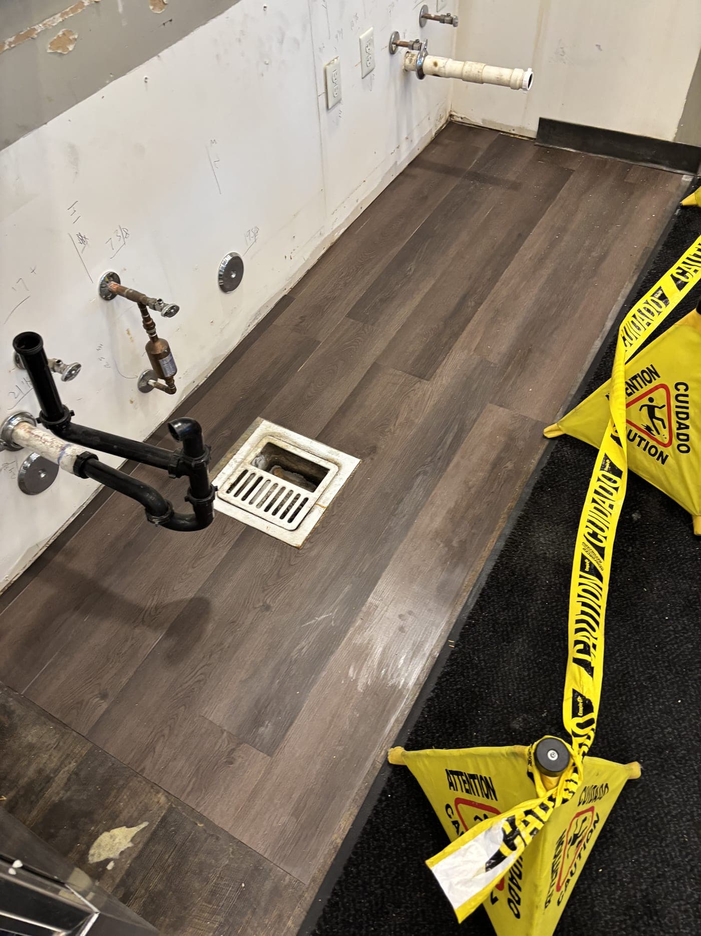 Wet-floor caution signs placed at standing water on a Resolve Residential Restoration job