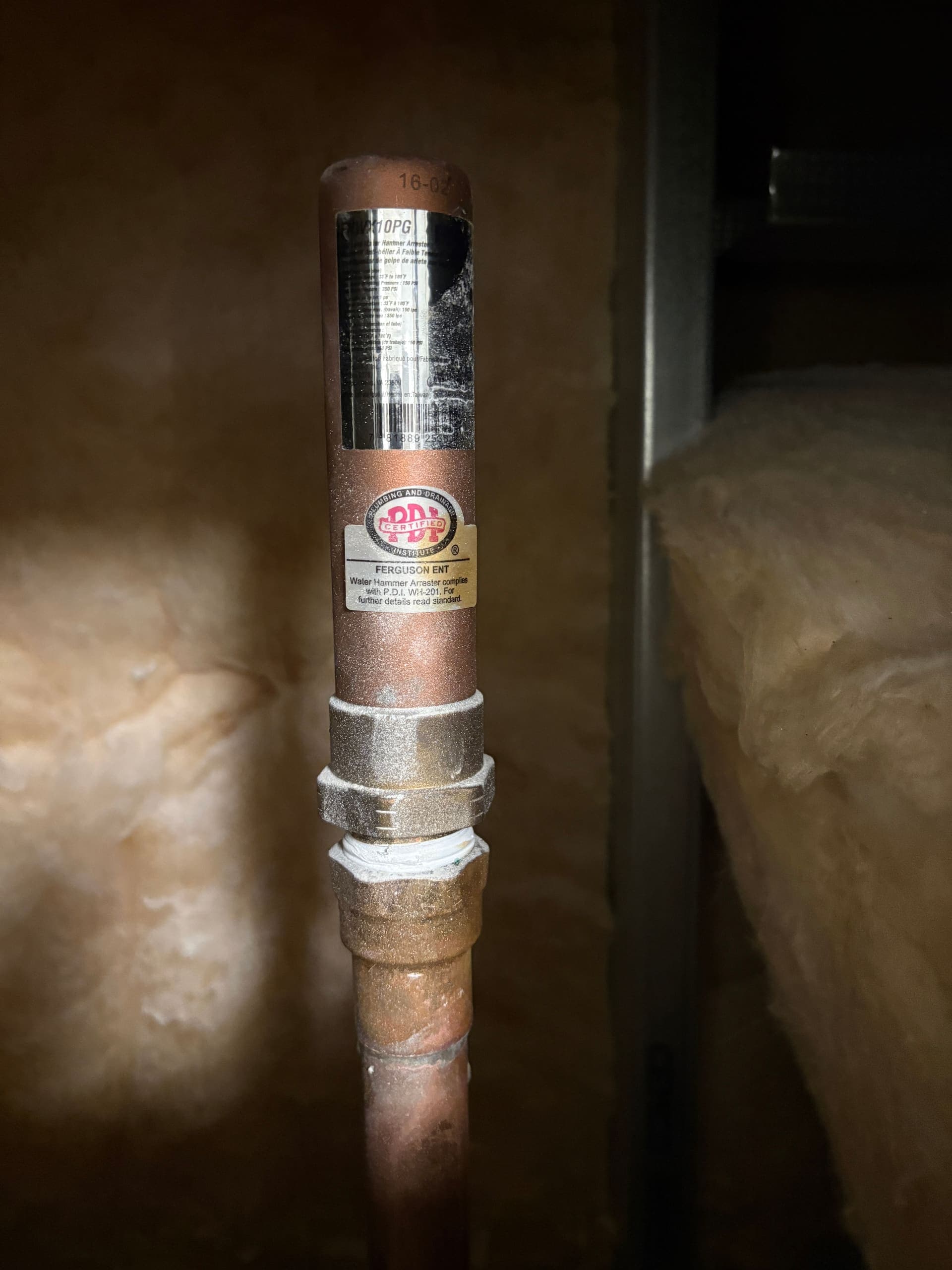 A copper pipe joint in the cavity above a ceiling