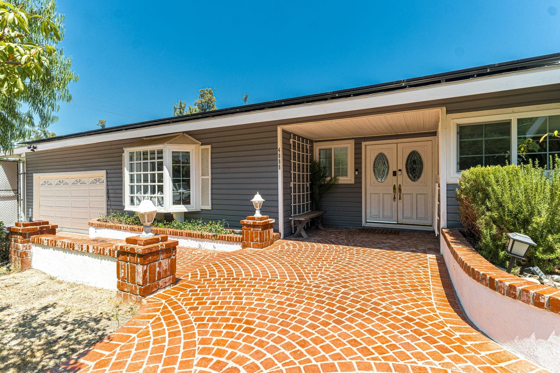 A Temecula ranch-style home with a brick driveway