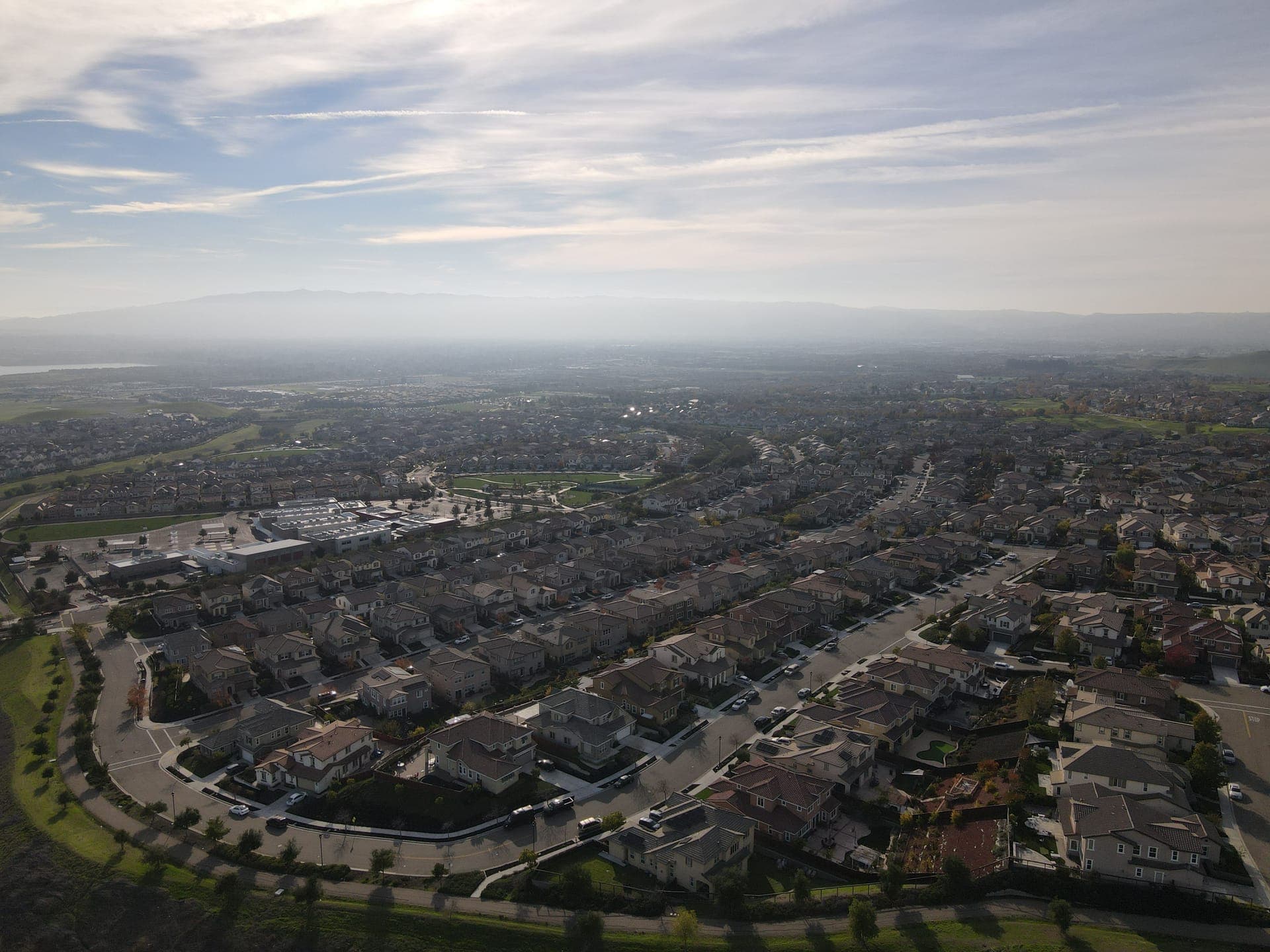 A Southern California valley neighborhood below hazy foothills