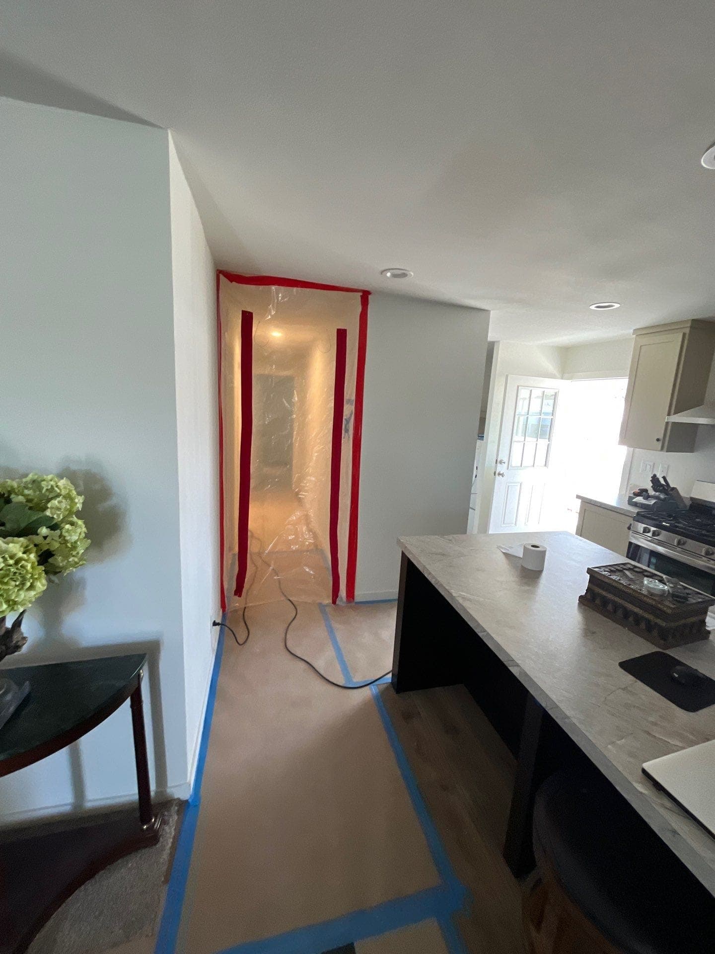 A containment barrier with a zippered doorway sealing off the work area on a Resolve Residential Restoration job