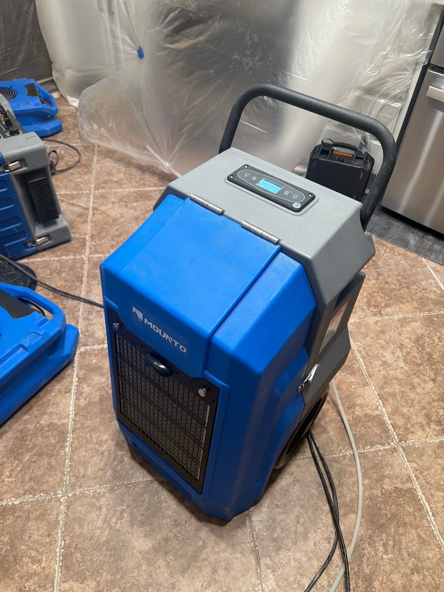 Commercial dehumidifier running on a Resolve Residential Restoration structural drying job