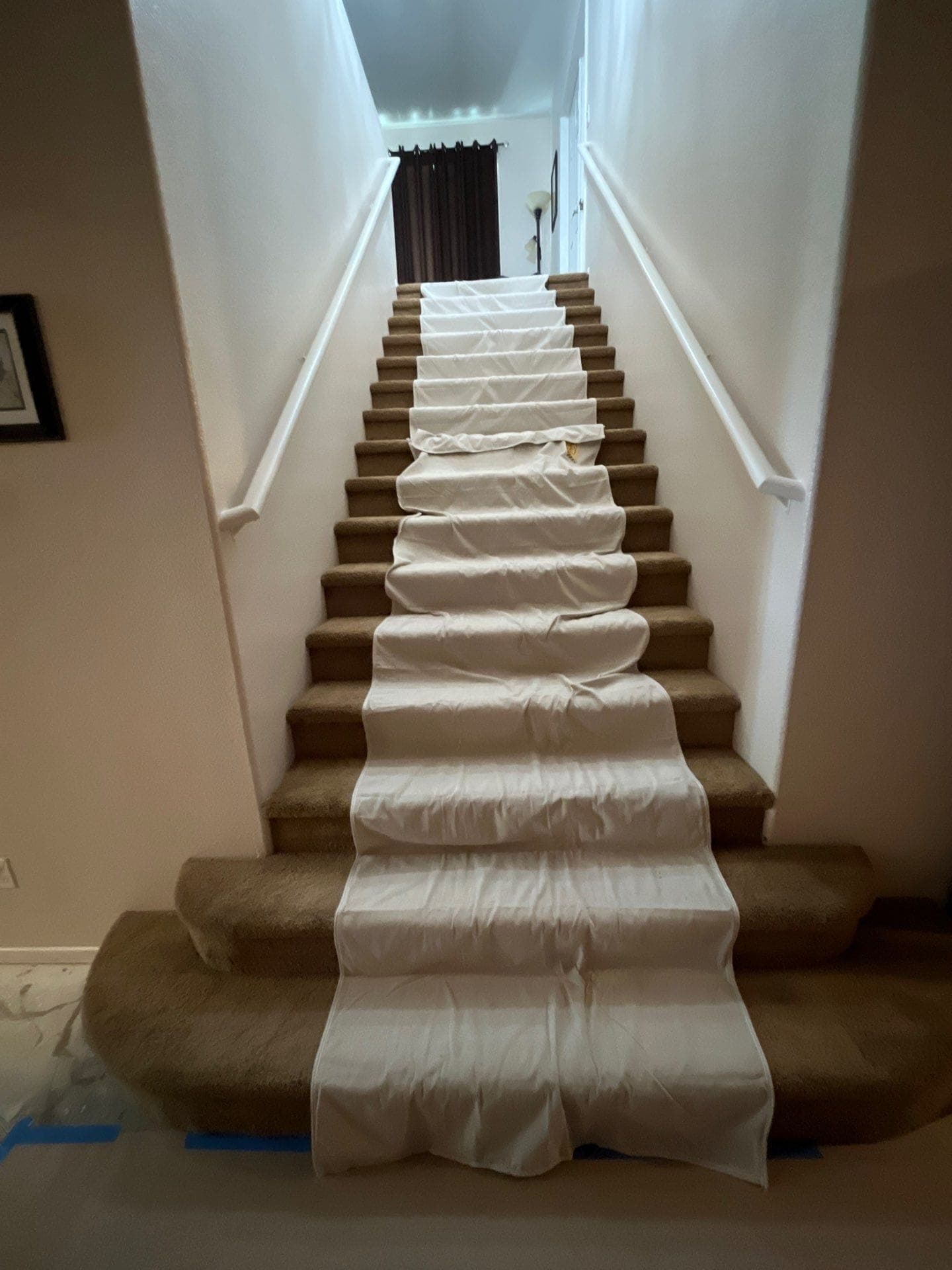 A staircase covered with protective material during a Resolve Residential Restoration job